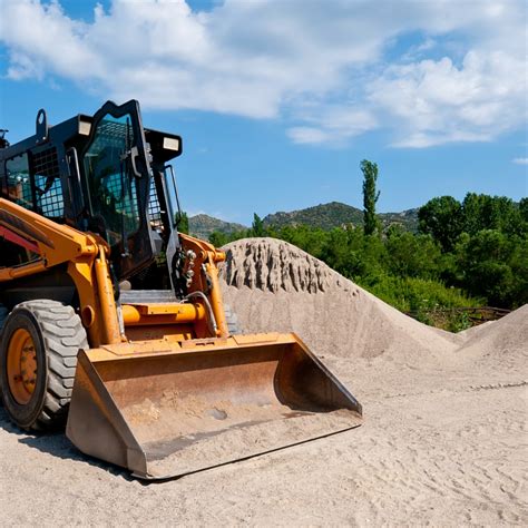 skid steer loader and operator|operating a skid steer loader.